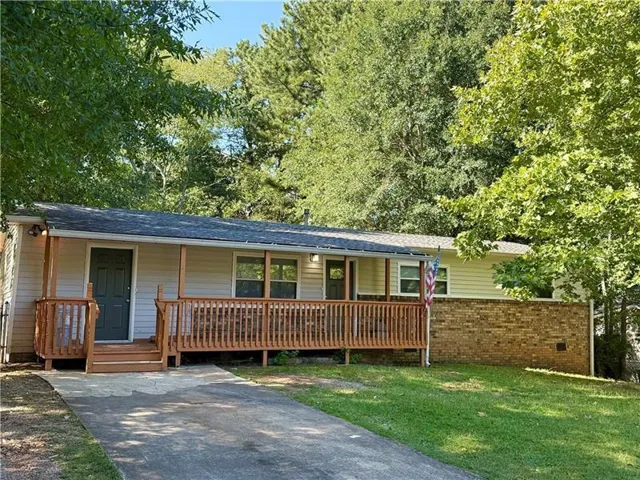 Ranch-style exterior with vinyl siding and a brick foundation