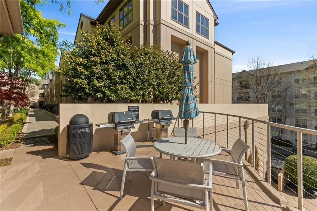 View of patio / terrace featuring an outdoor kitchen and a grill