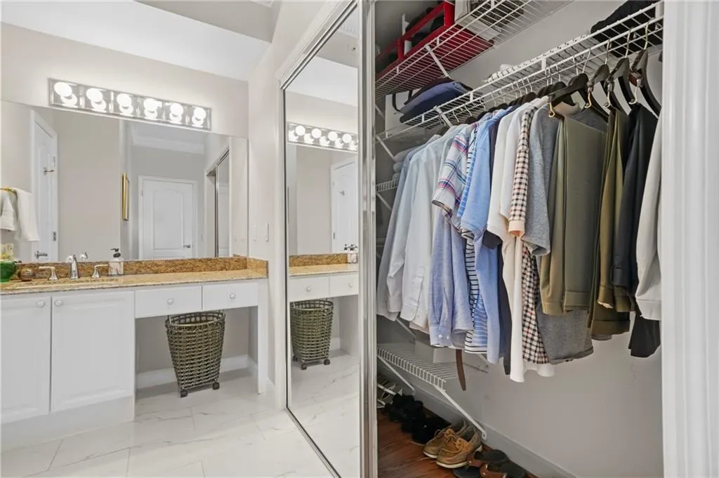 Spacious closet featuring a sink and light marble finish flooring