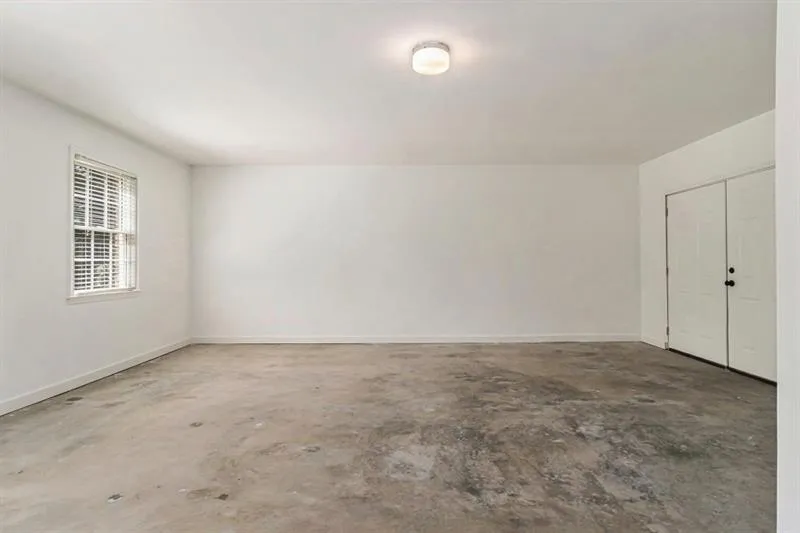 Unfinished room on Main Level with Cement Floor