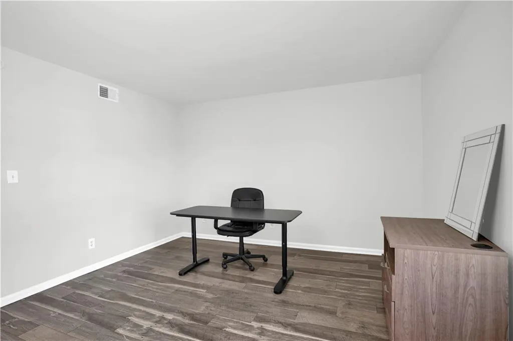 Office space with dark wood-style flooring