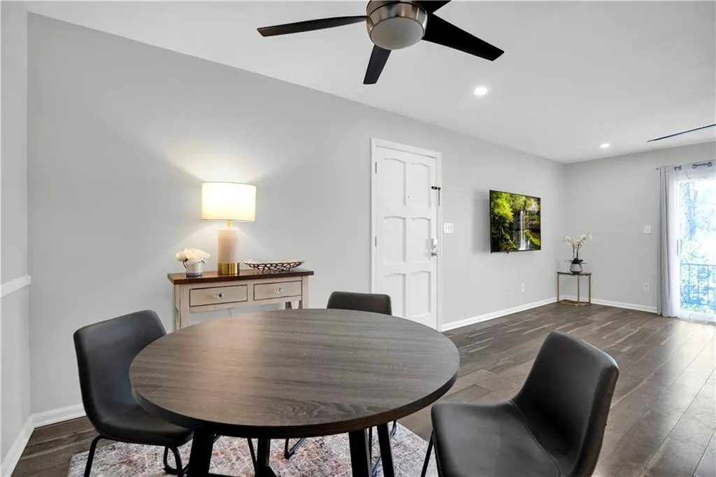Dining area featuring dark wood finished floors, a ceiling fan, and recessed lighting