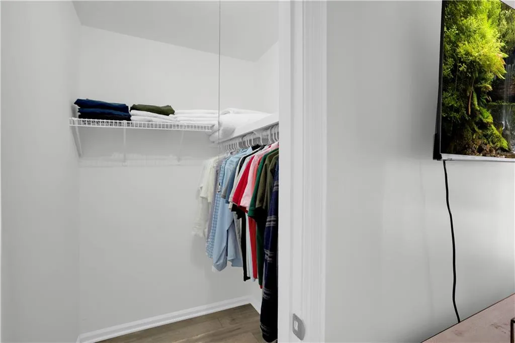 Walk in closet featuring wood finished floors