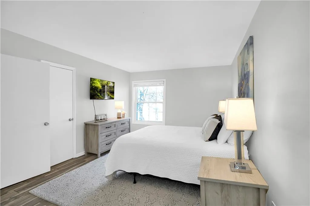 Bedroom with dark wood-style flooring