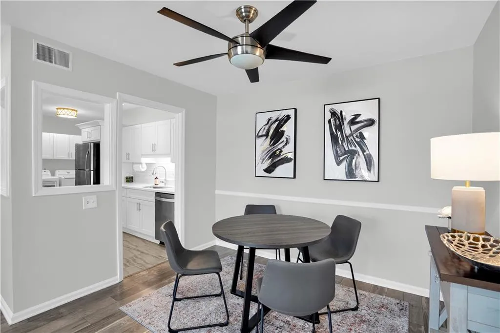 Dining room featuring dark wood-style floors, and ceiling fan