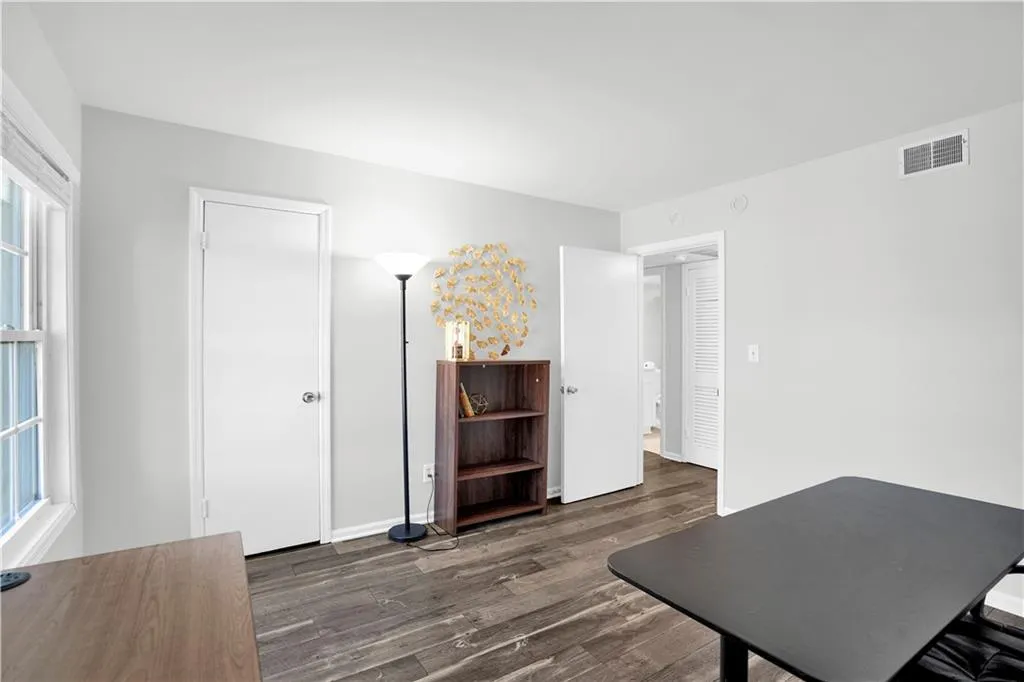 Office featuring dark wood-style flooring and baseboards