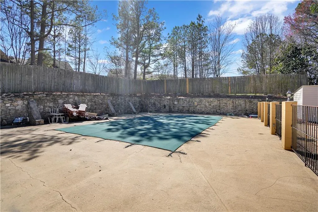 View of pool with a fenced backyard and patio surround