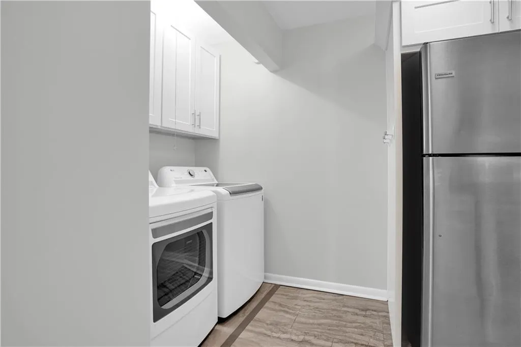 Laundry area with baseboards and separate washer and dryer