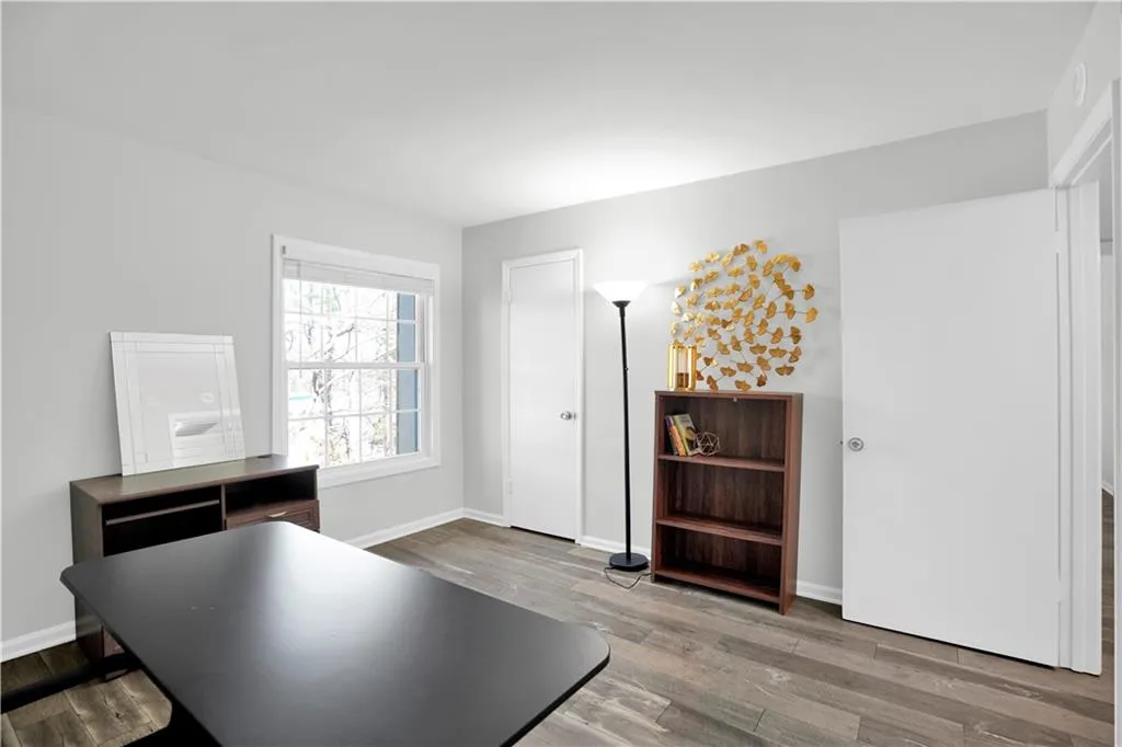 Home office featuring light wood finished floors and baseboards
