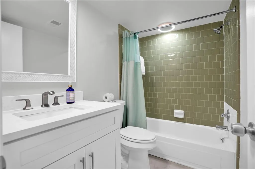 Bathroom featuring vanity and shower / bath combo