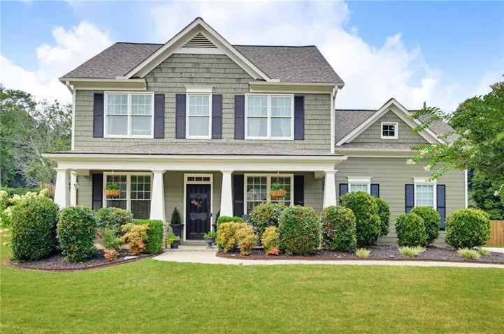 Two-story exterior with a covered front porch and dormer windows