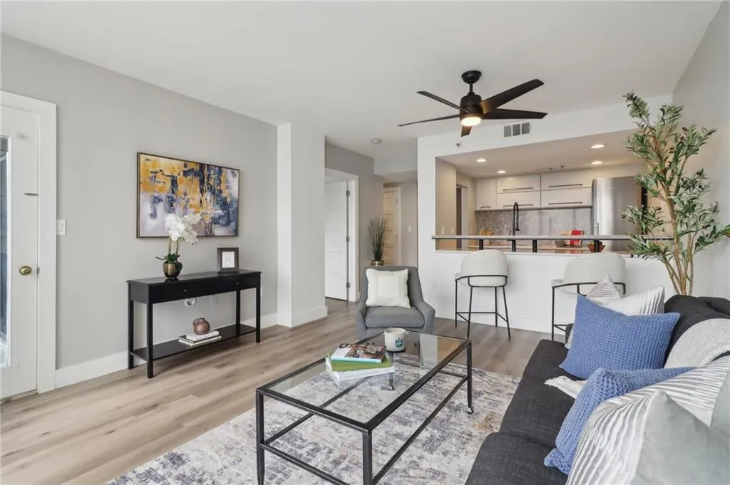 Living room with a ceiling fan, light wood-style flooring, recessed lighting, and baseboards