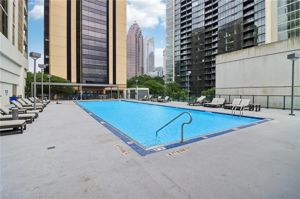 Community pool featuring a city view and a patio