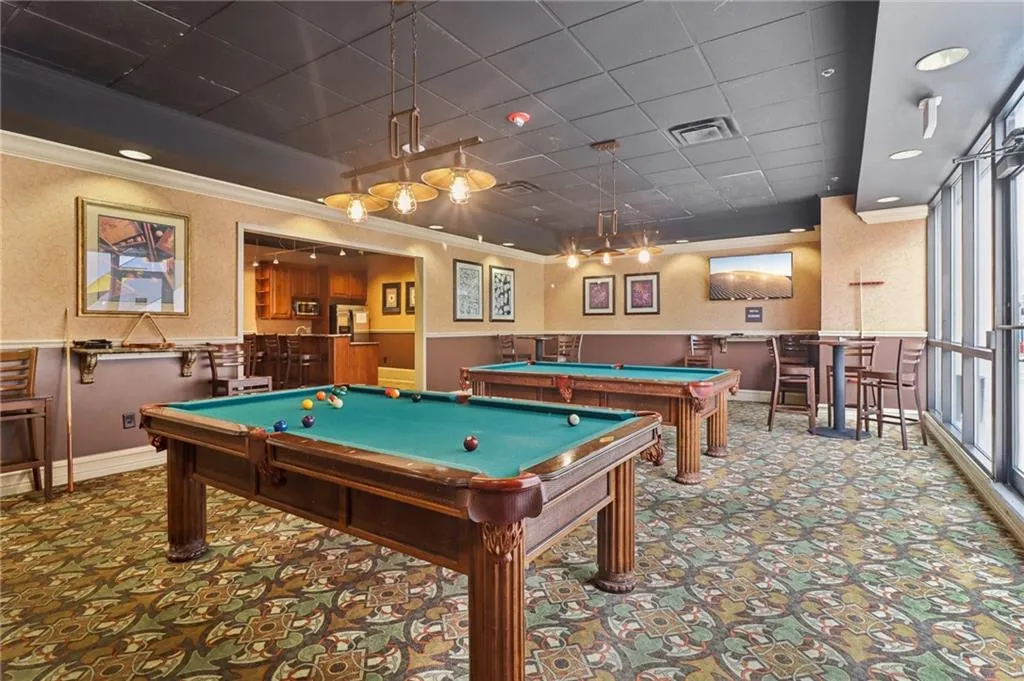 Game room featuring billiards table, crown molding, wainscoting, carpet, and a paneled ceiling