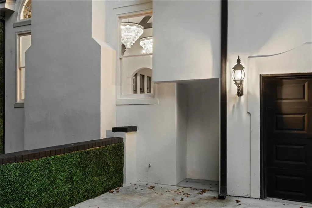 Property entrance featuring stucco siding and a garage