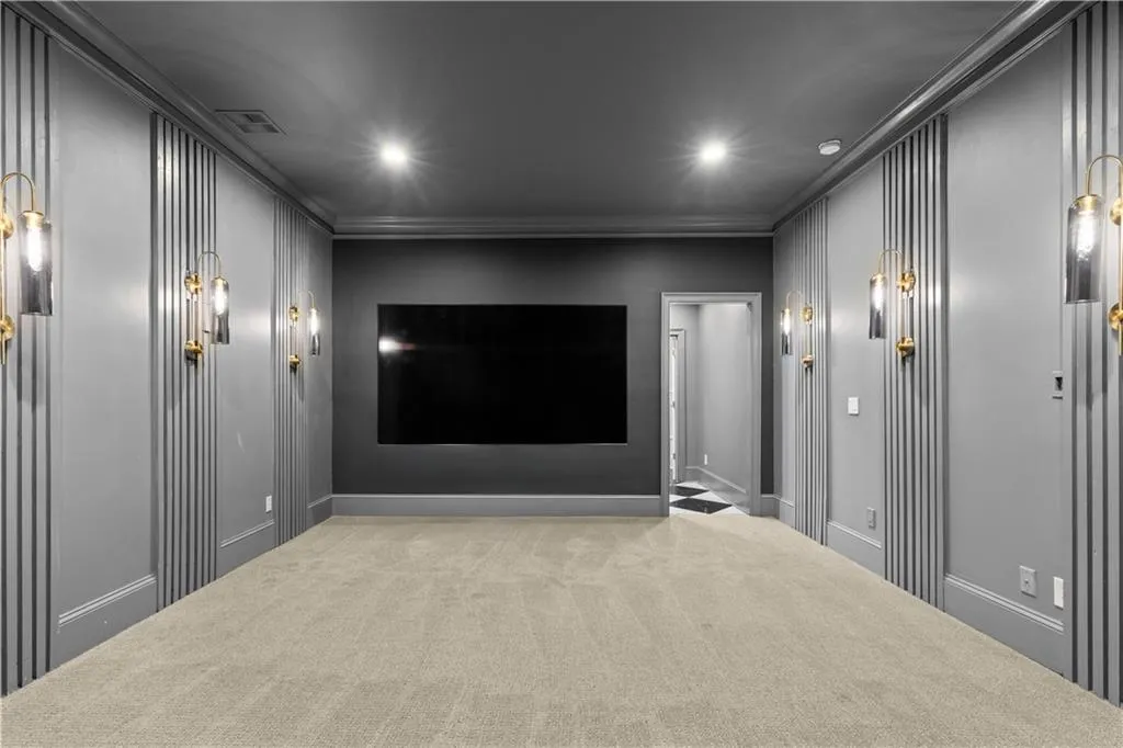 Cinema with carpet floors, crown molding, and recessed lighting