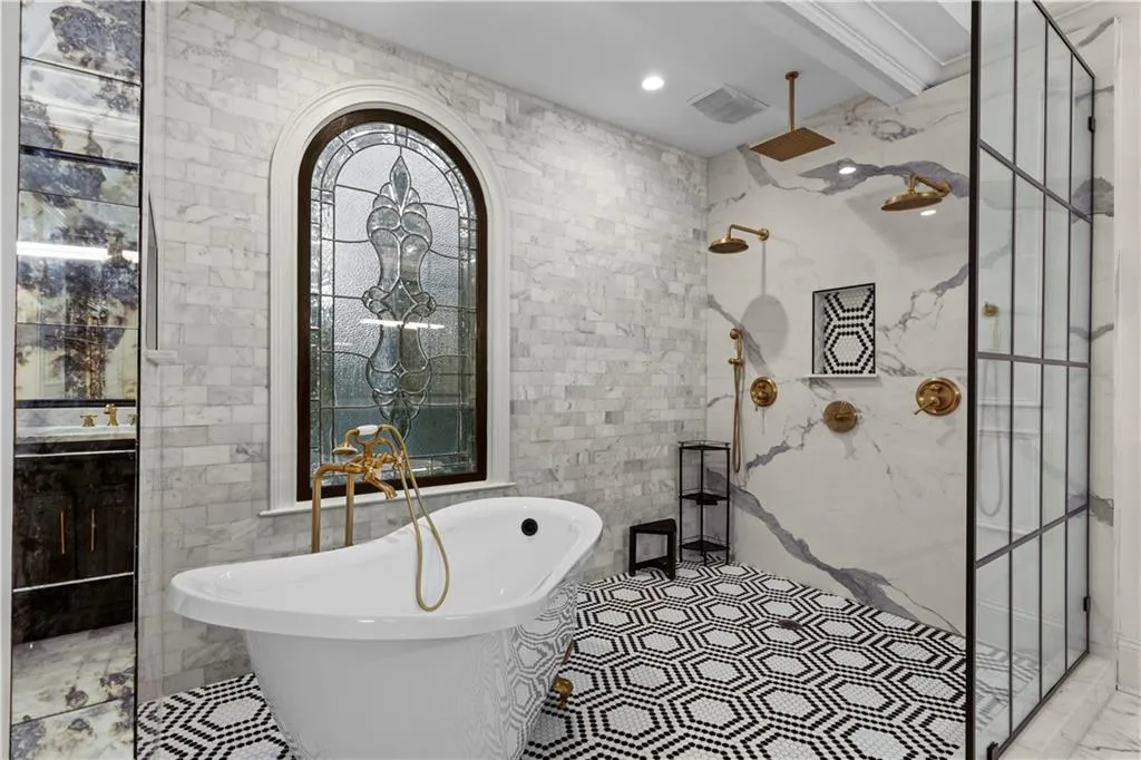 Full bath with tile walls, a freestanding bath, a marble finish shower, and recessed lighting