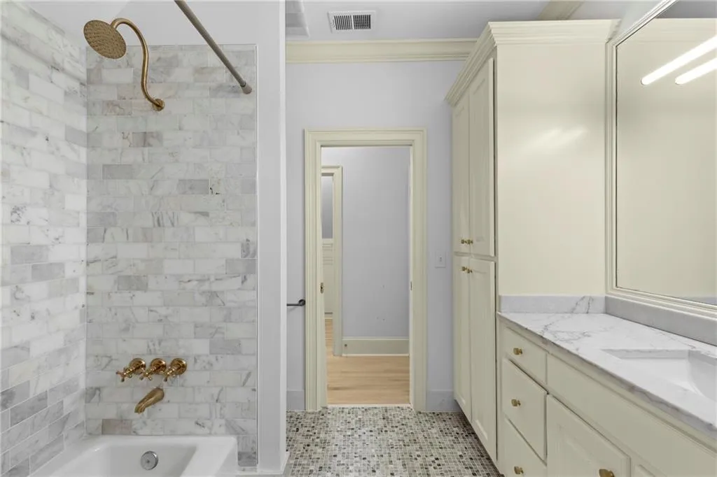 Full bathroom with  shower combination, vanity, crown molding, and light tile patterned flooring