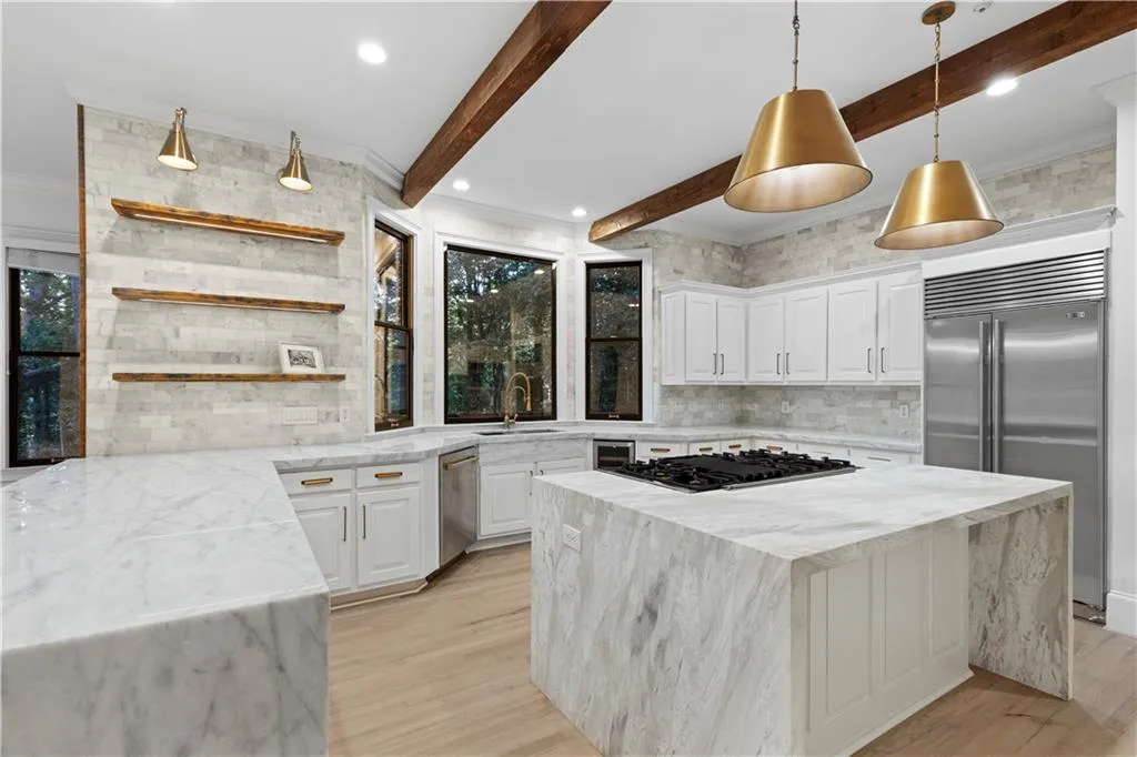 Kitchen featuring light stone counters, tasteful backsplash, a kitchen island, open shelves, and beam ceiling
