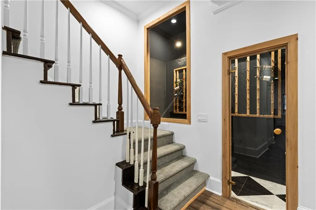 Stairs with wood finished floors and ornamental molding
