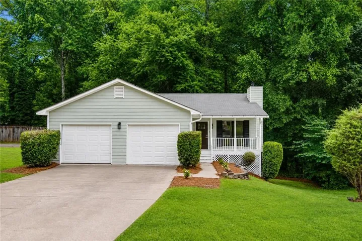 Light-colored siding exterior with a two-car garage