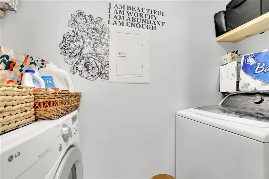 Laundry room with washer and dryer and electric panel