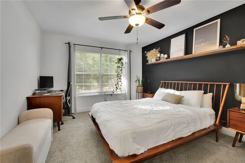 Bedroom with light carpet and ceiling fan