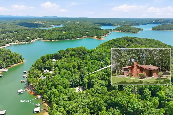 Waterfront property with multiple docks and mature surrounding trees