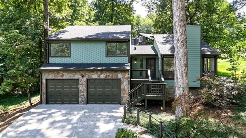 Split-level exterior with stone cladding and board and batten siding