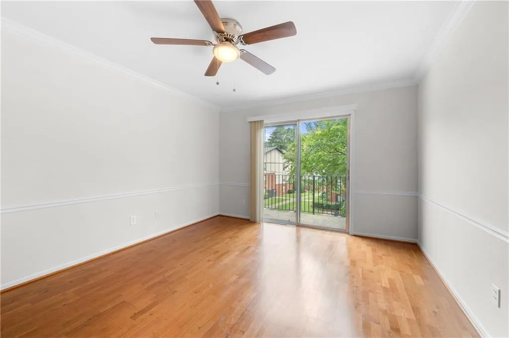Unfurnished room featuring light wood-type flooring, ceiling fan, and crown molding