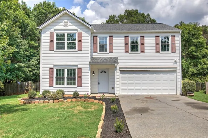 Two-story white siding exterior with contrasting shutters