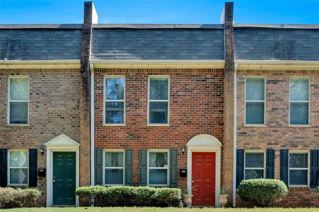 Gorgeous Townhome with the Red door, featuring a large front yard