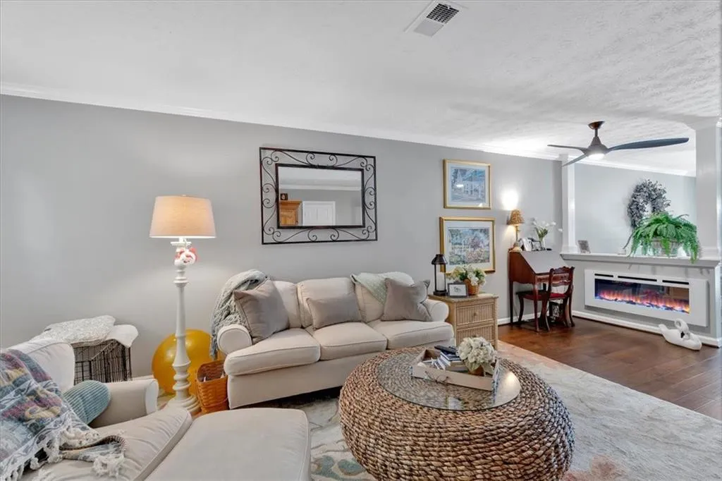 Living room featuring gorgeous custom fireplace with remote.