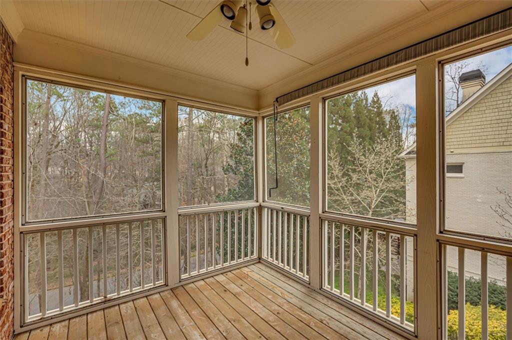 Unfurnished sunroom with ceiling fan