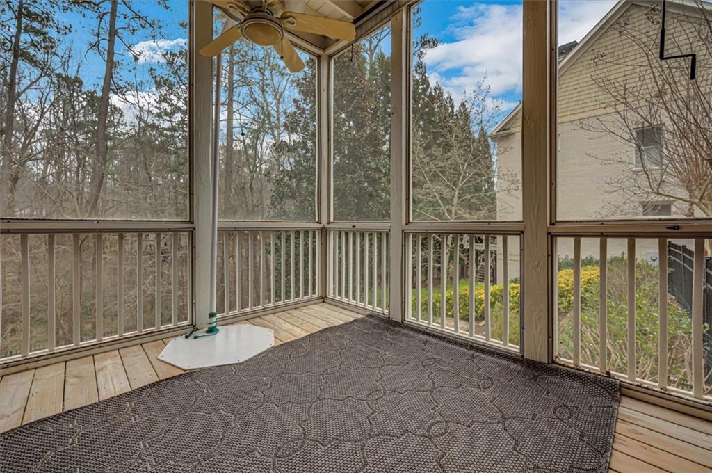 Unfurnished sunroom with ceiling fan