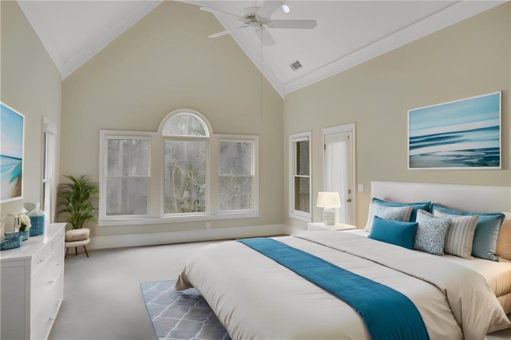Bedroom featuring high vaulted ceiling, crown molding, carpet, and ceiling fan