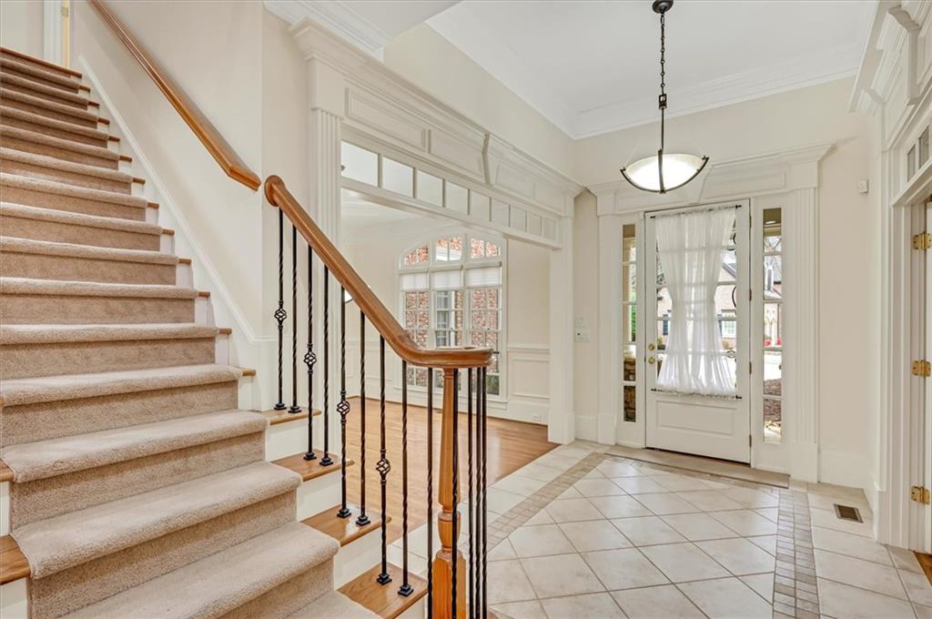 Tiled foyer entrance with crown molding