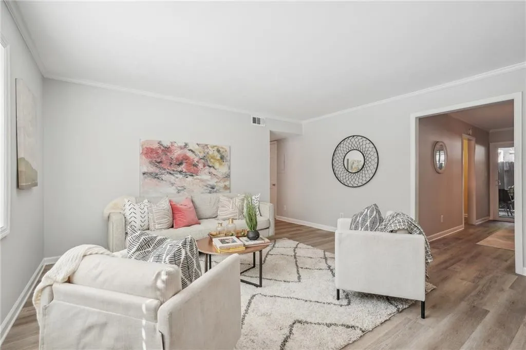 Living room featuring ornamental molding and hardwood / wood-style floors