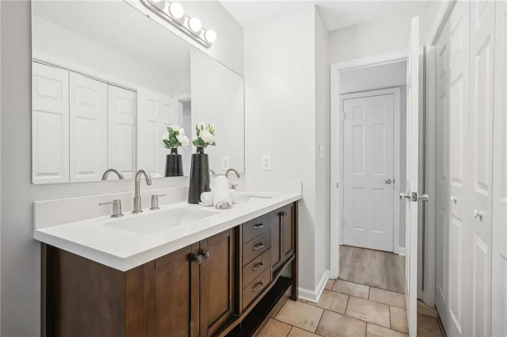 Bathroom featuring tile flooring and double sink vanity