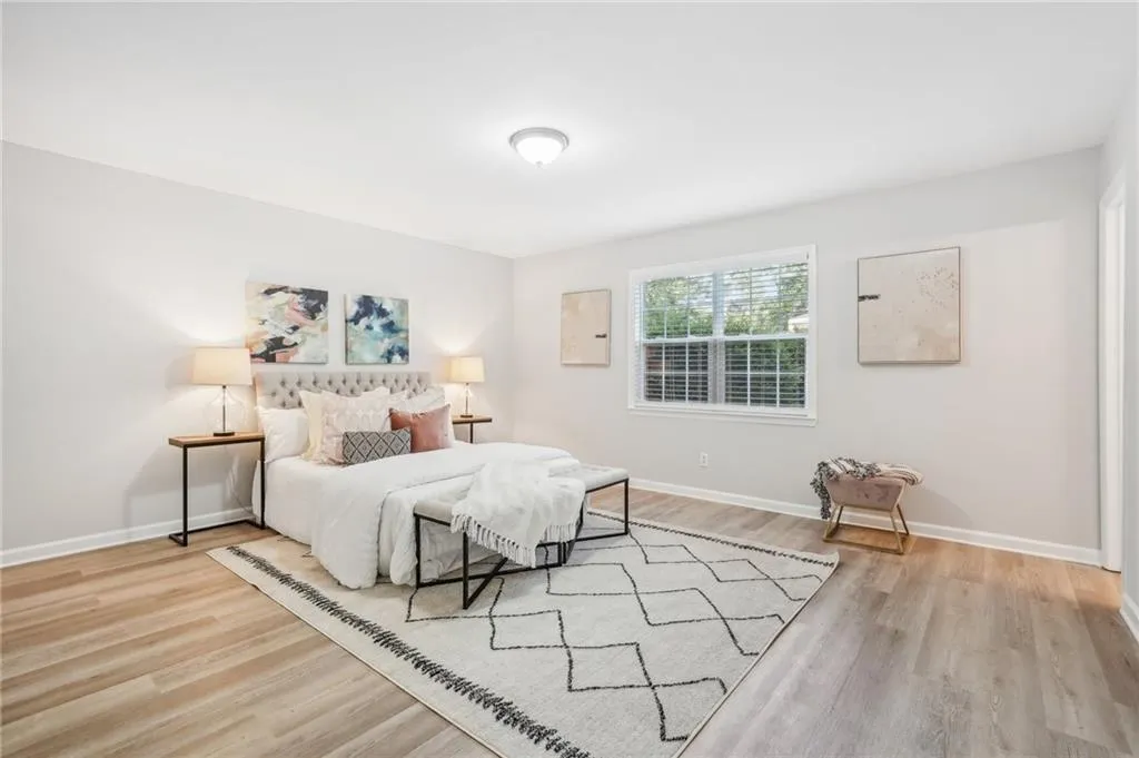Bedroom with light hardwood / wood-style flooring