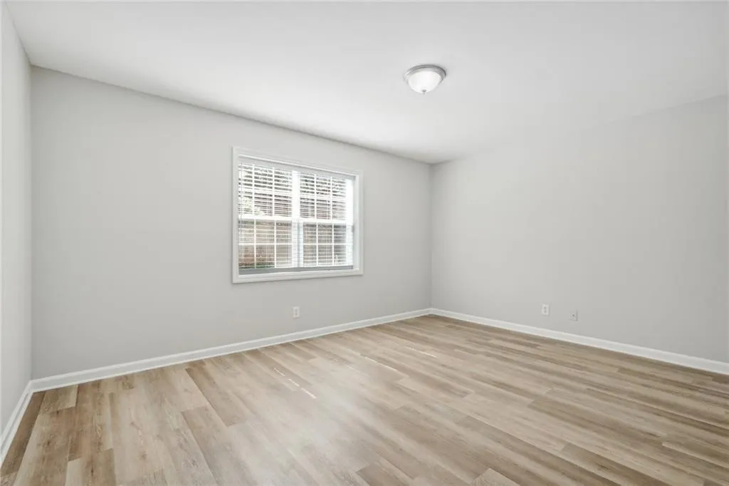 Unfurnished room with light wood-type flooring