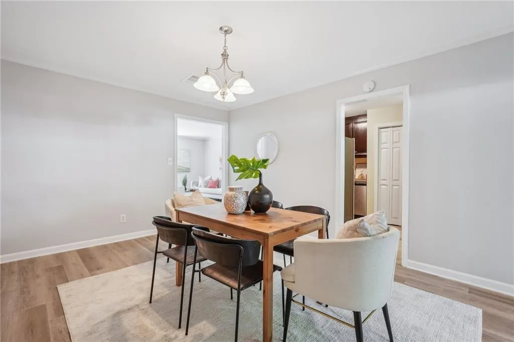 Dining area featuring a notable chandelier and light hardwood / wood-style flooring