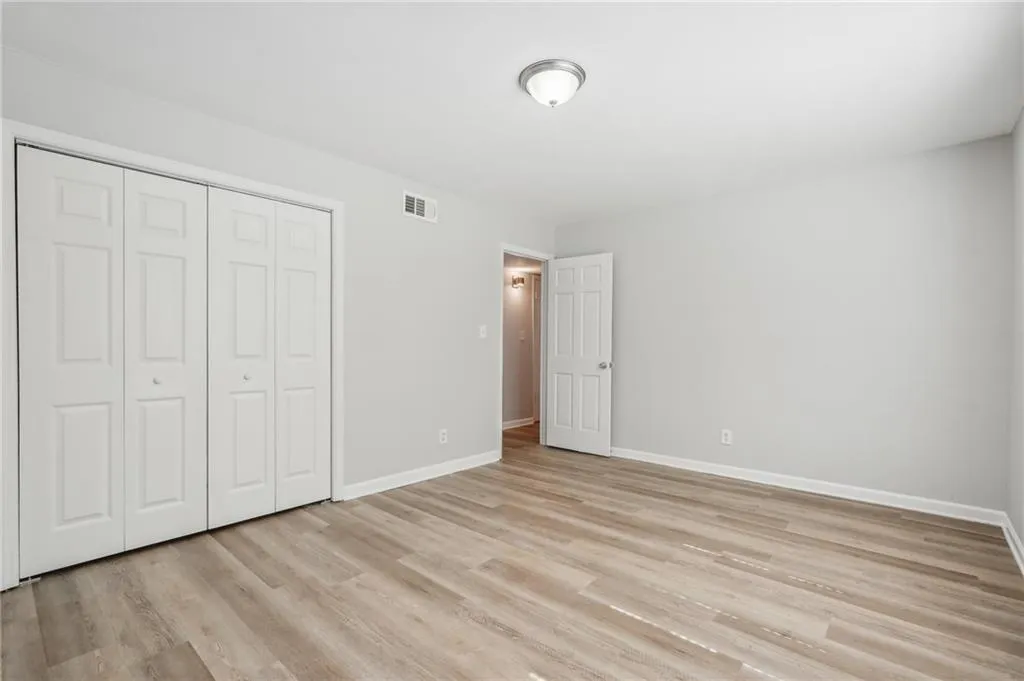 Unfurnished bedroom featuring light hardwood / wood-style floors and a closet