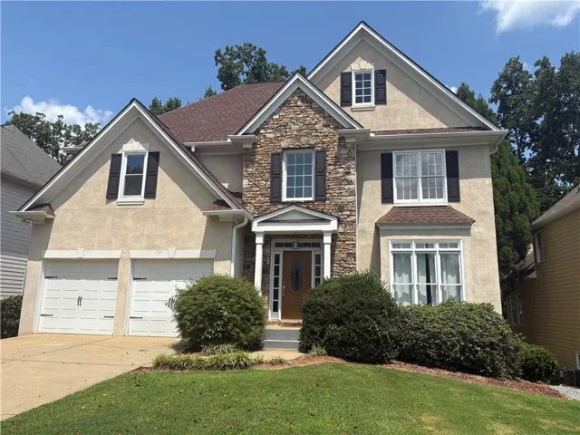 Stucco and stone exterior with architectural shingles
