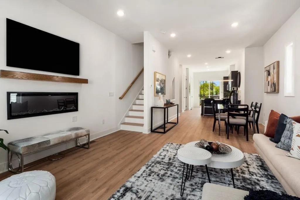 Living area featuring recessed lighting, light wood-type flooring, and stairs