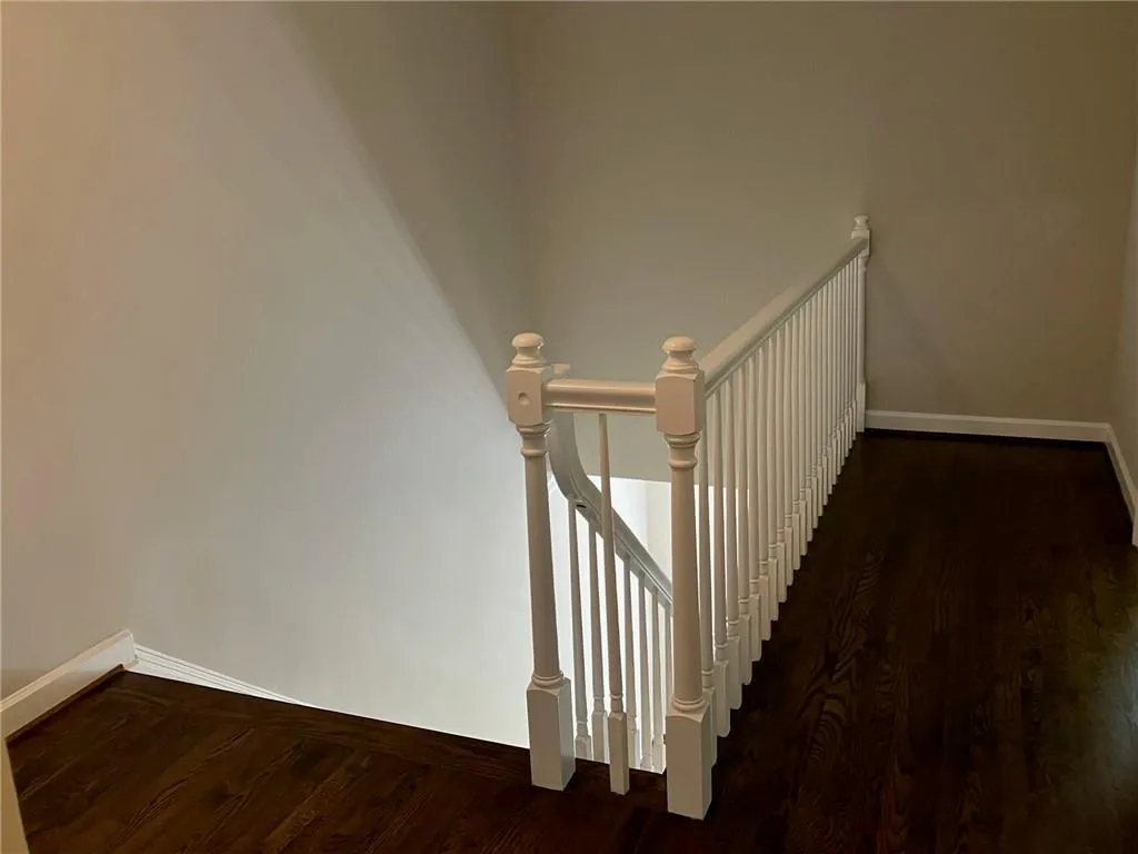 Stairs featuring dark wood-type flooring