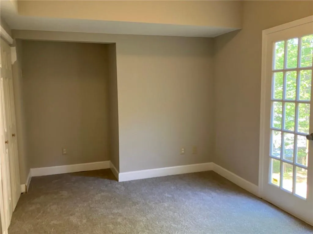 Carpeted empty room featuring a healthy amount of sunlight