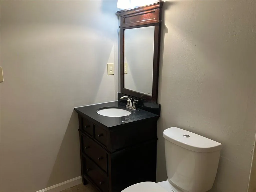 Bathroom with oversized vanity and toilet