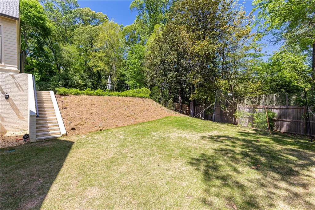 Stairs from pool level to lower level yard