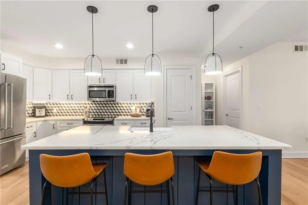 Upgraded pendant lighting and spacious counter sitting makes this a focal point of the unit.